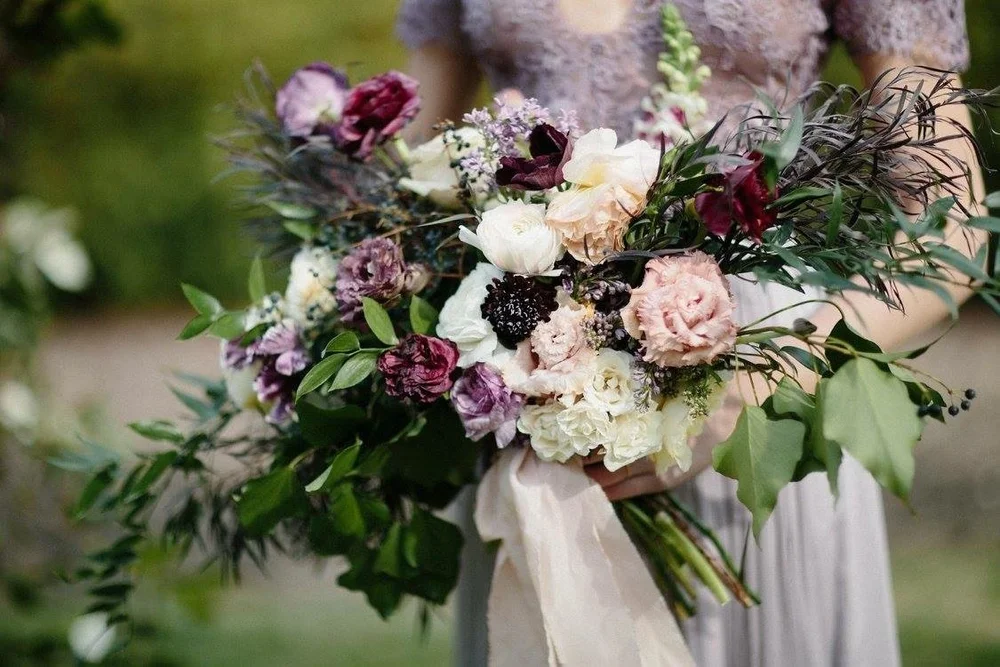 Artful wedding bouquet in ivory, plum, and green