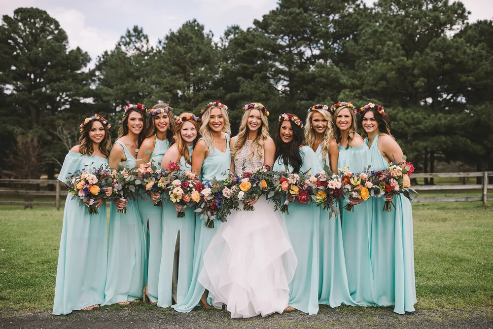 Wedding party carrying colorful bouquets